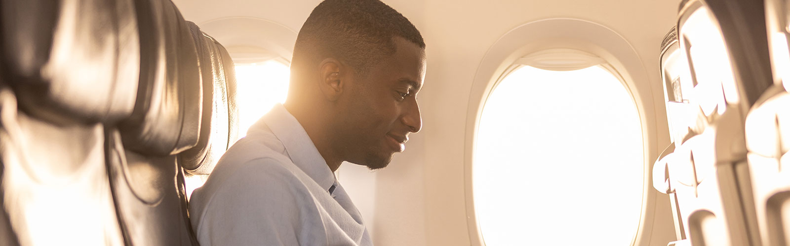 Man on computer while in an airplane