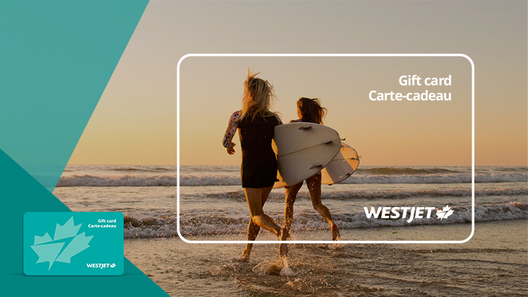Two friends running into the ocean with surfboards