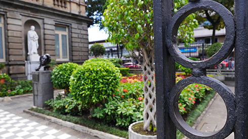Iron gate with a garden pathway into the National Theater in San Jose,